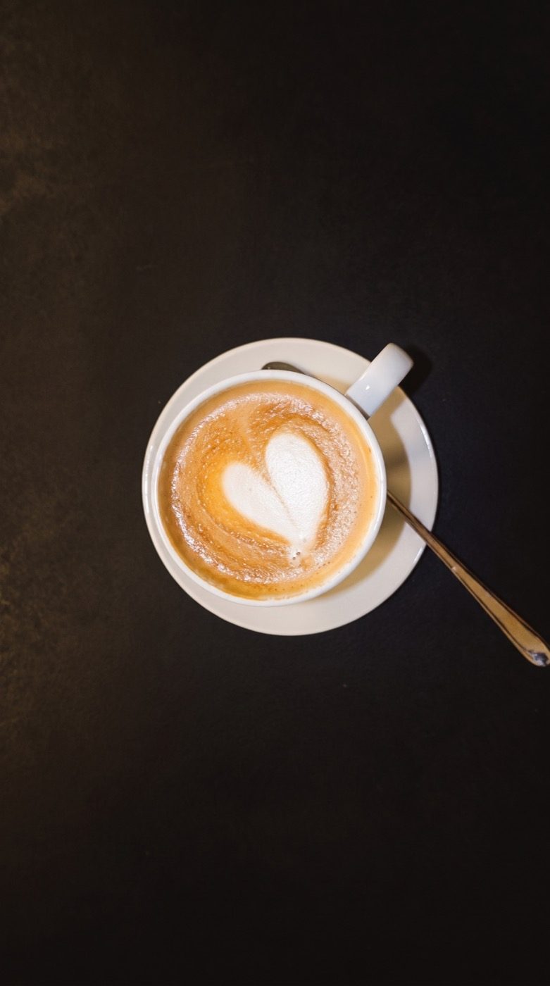 Flat white with heart latte art, shot from above, on our Instagram