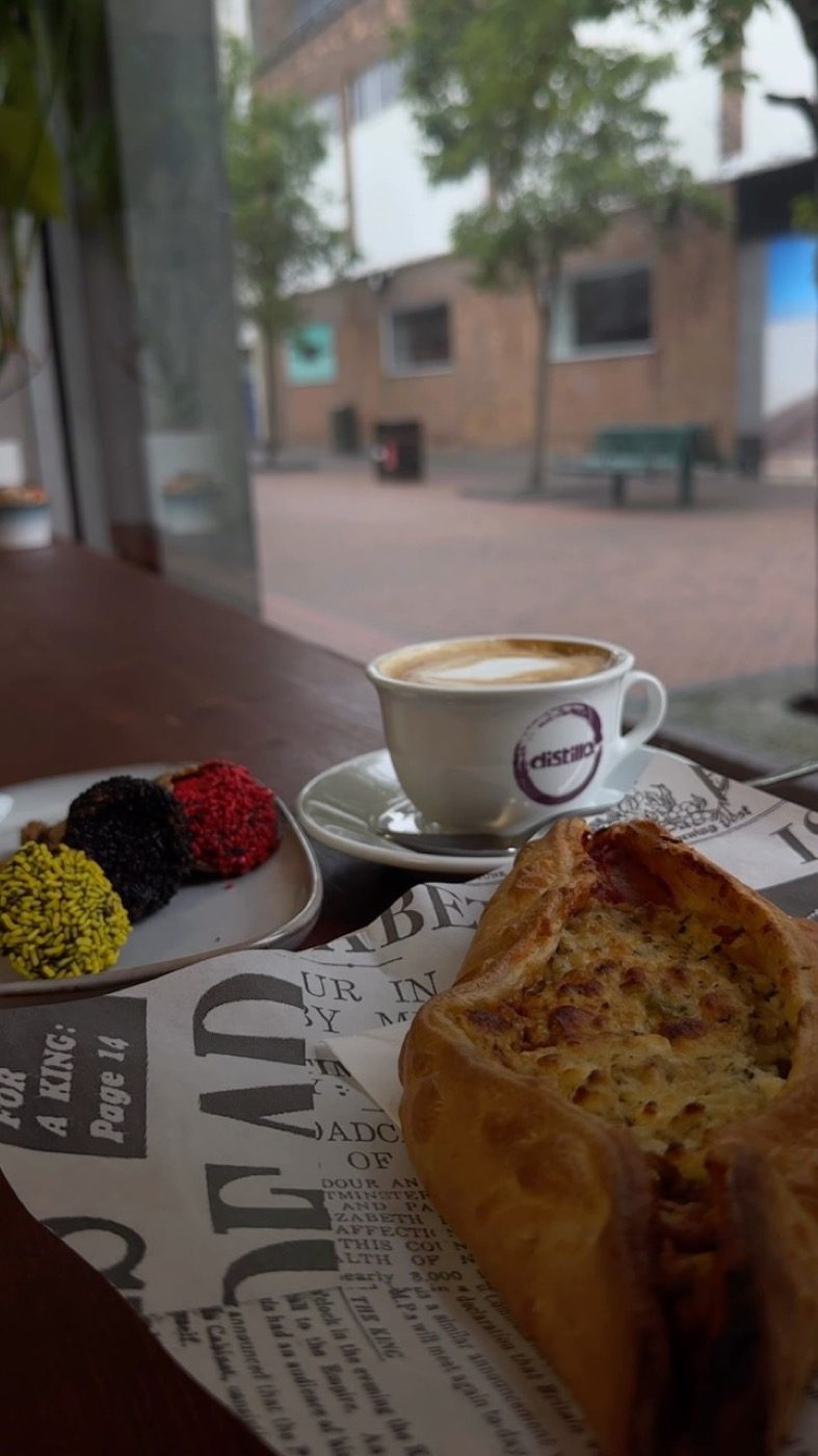 Peinirli and a cappuccino on the window bench looking out at Dundas Street