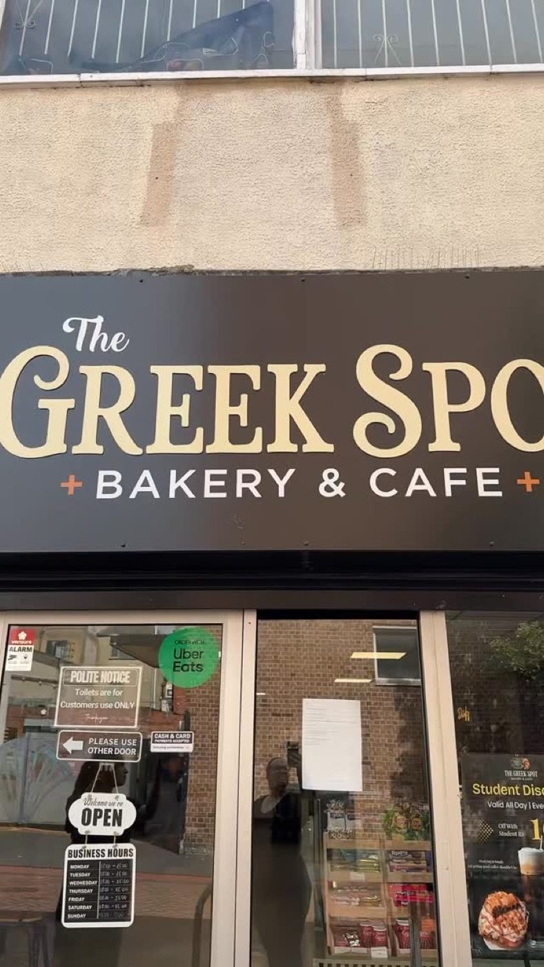 The Greek Spot shopfront on Dundas Street with its black and gold sign